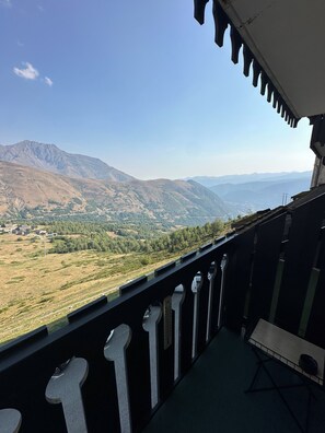 A balcony with a view of a mountainous landscape.