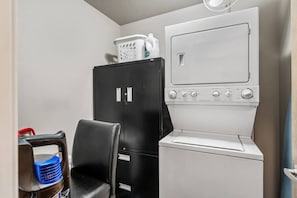 A compact kitchenette with a refrigerator, a microwave, and a sink. - 2 Bed 2 Bath | Mins to Stampede | AC (Calgary)
