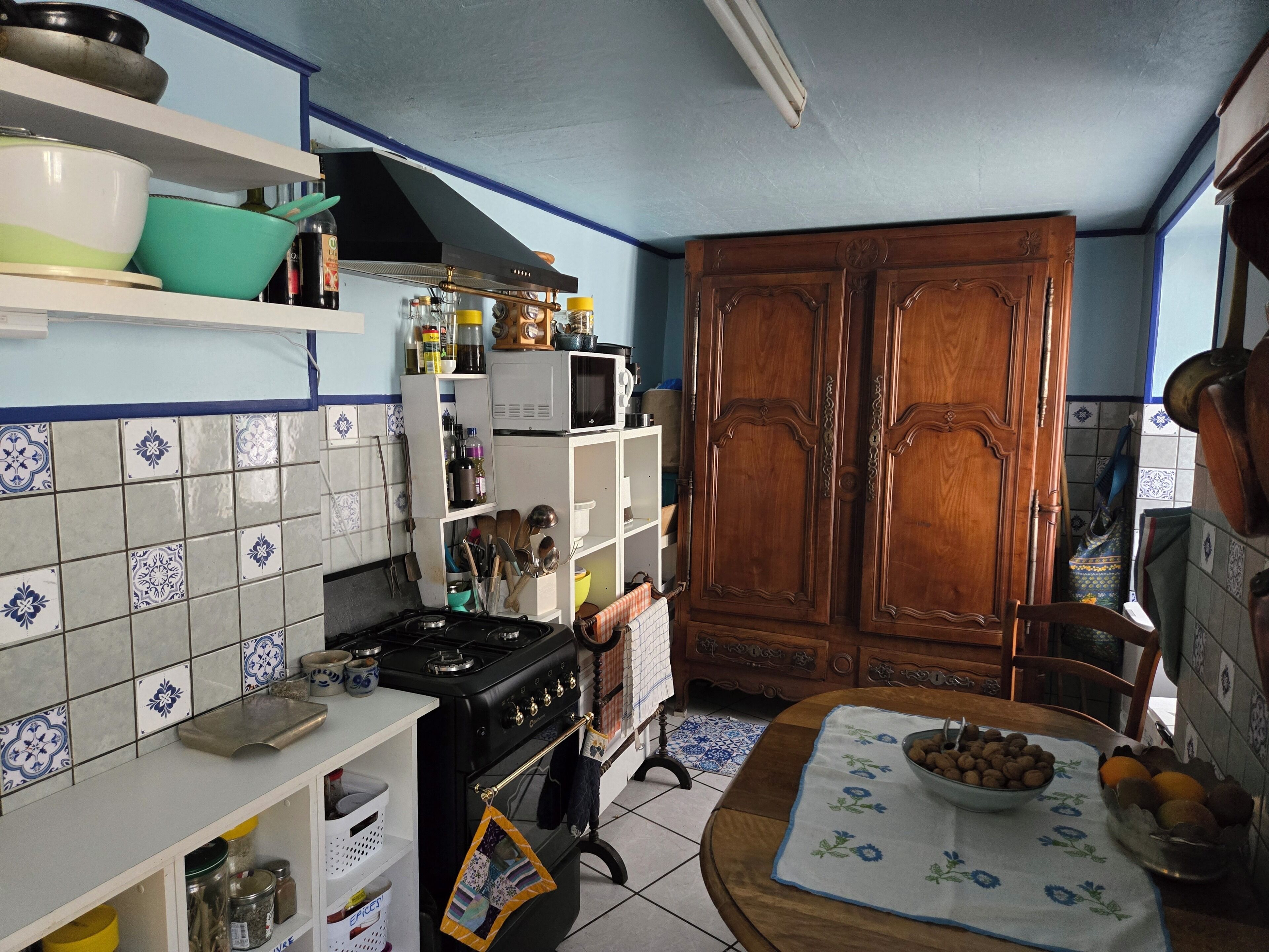 A kitchen with a stove, cabinets, and a microwave.
