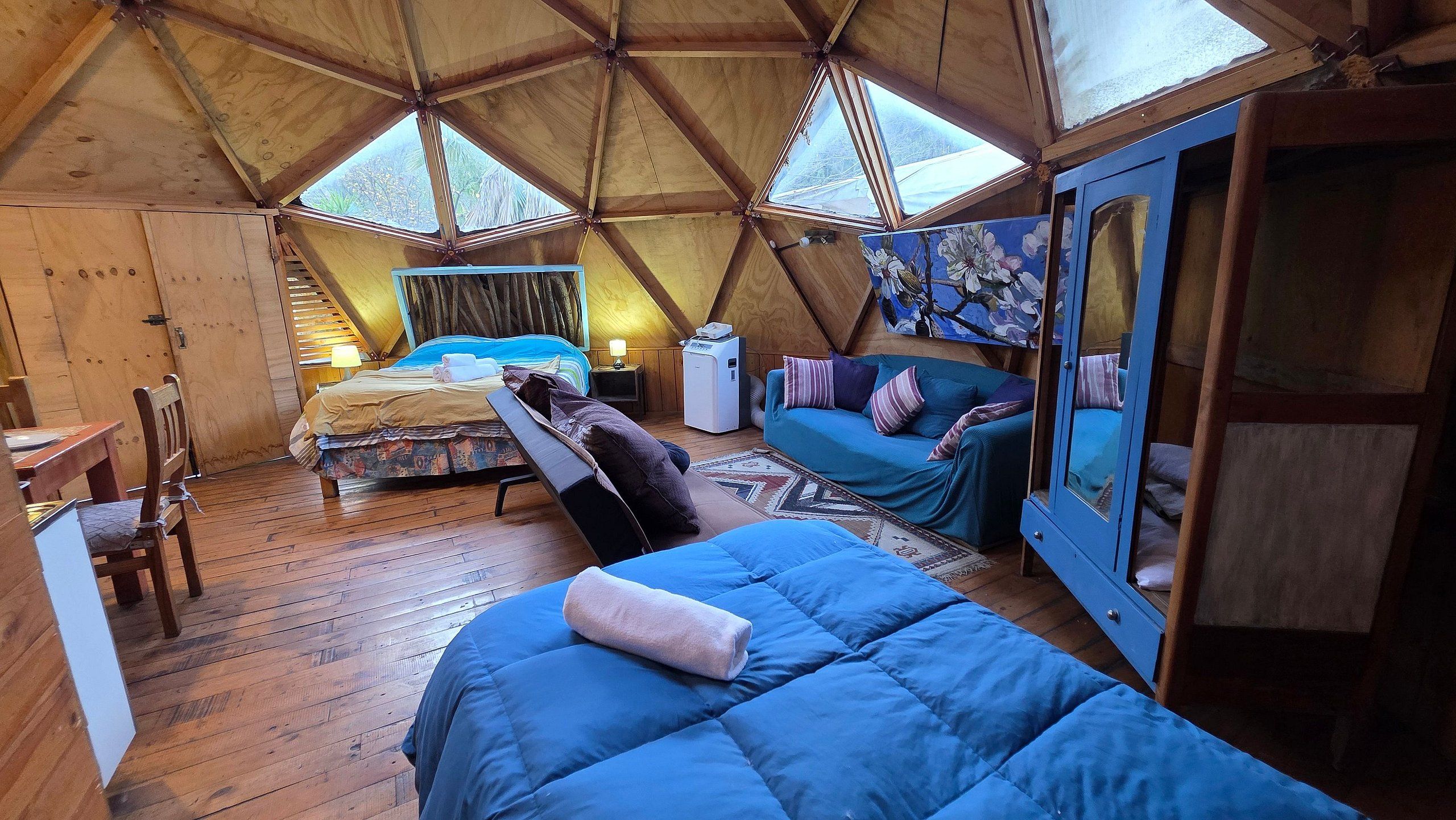 A cozy interior with a bed, a sofa, and a wardrobe.