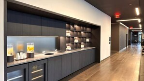 A modern hotel lobby with a long reception desk, a glass partition, and a wooden floor. - 2 Bedrooms Condo with Balcony & Amazing Views in Downtown (Miami)
