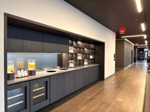A modern hotel lobby with a long reception desk, a glass partition, and a wooden floor. - 2 Bedrooms Condo with Balcony & Amazing Views in Downtown (Miami)