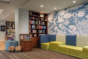 A children's reading area with a bookshelf, seating, and a wall mural. - 3 Bedroom Villa at Westin Nanea Ocean Resort (Lahaina)