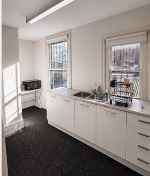Full-sized fridge, microwave, cookware/dishes/utensils