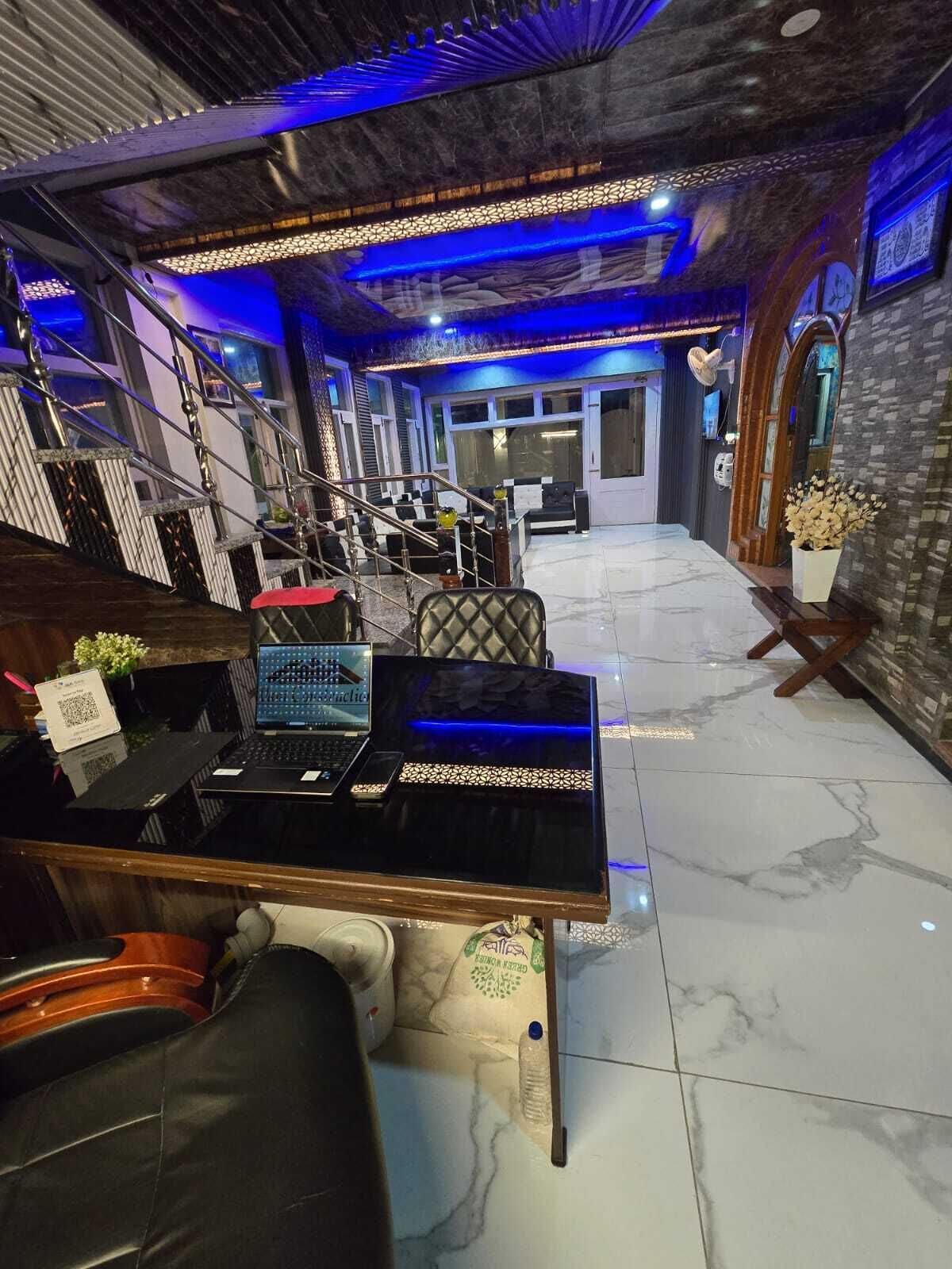 A reception area with a desk, chairs, and a staircase.
