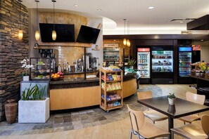 A modern kitchen area with a flat-screen TV, a coffee machine, and a variety of food items on display. - 1 Bedroom Villa at Scottsdale Resort Kid-Friendly (Scottsdale)