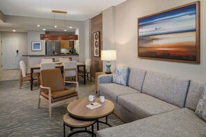 A modern hotel room with a sofa, chairs, a dining table, and a kitchen area. - 1 Bedroom Villa at Scottsdale Resort Kid-Friendly (Scottsdale)