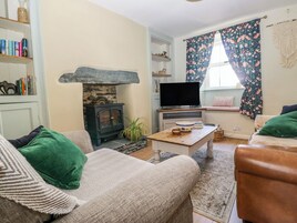A cozy living room with a fireplace, a television, and comfortable seating.