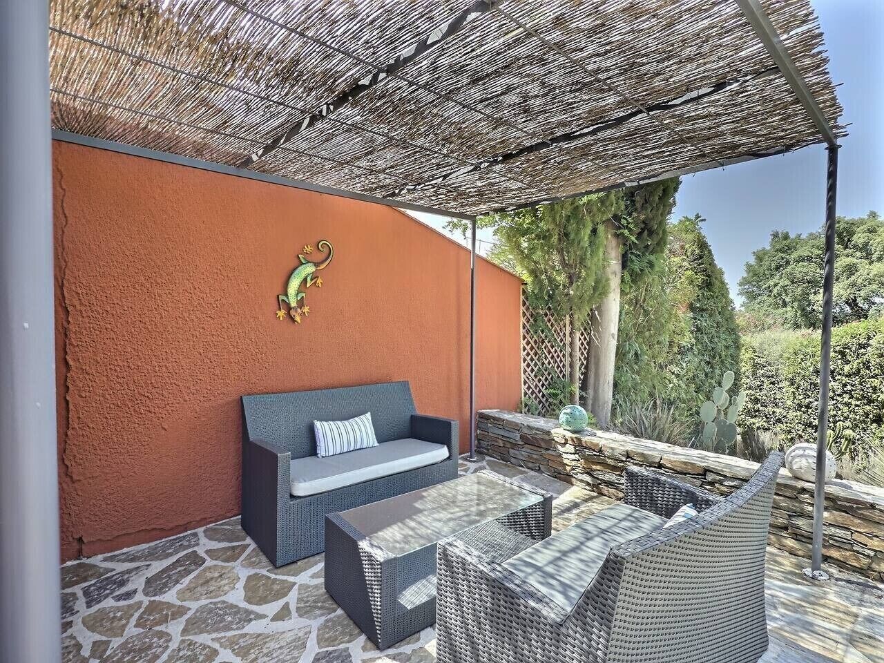 Un espacio al aire libre con sofás, sillas y una mesa.