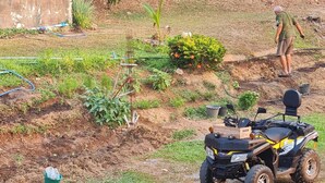 A quad bike parked in a garden with a small bush and a hose. - Mountain Front Family Home Big Balcony For 4 Rare Birds, Bikes (Kaeng Krachan)