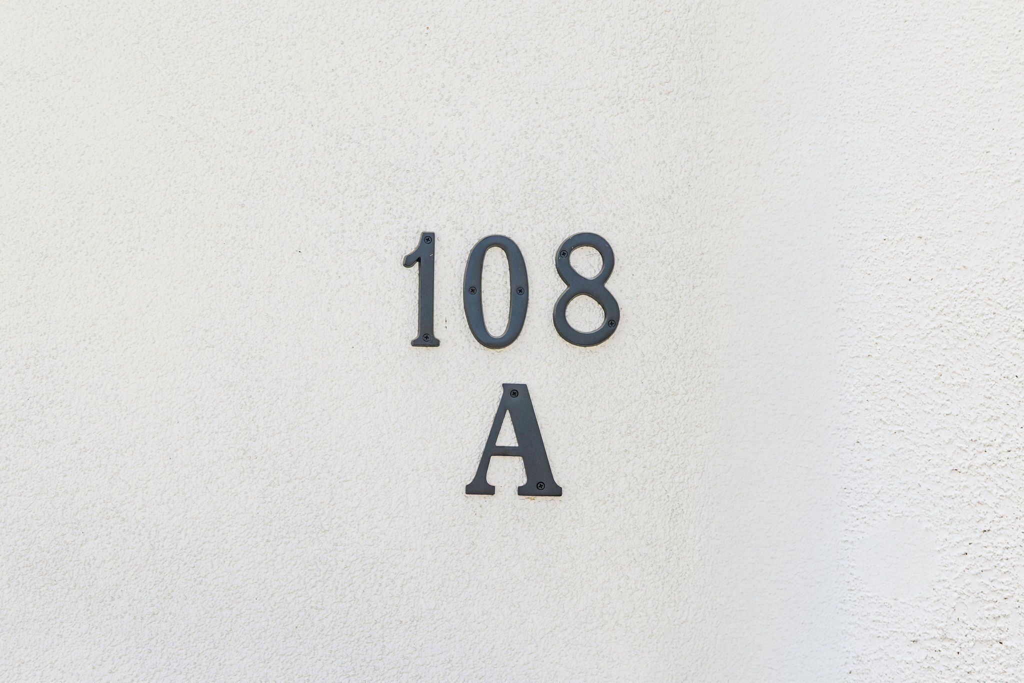 A wall with the numbers '108 A' embossed on it.