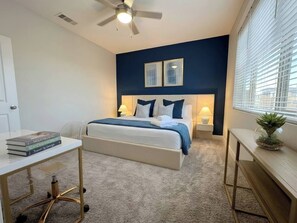 A bedroom with a bed, bedside tables, a desk, a ceiling fan, and a window with blinds. - North Scottsdale Resort Retreat | Pet Spa, W/D Gym (Scottsdale)