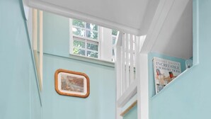 A staircase with light blue walls and wooden steps.