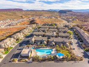 A residential area with houses, a swimming pool, and a hilly landscape in the background. - Heated Pool + Hot Tub • Pickleball • Close to Zion (Washington)