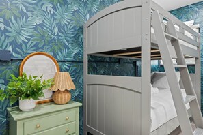 A bunk bed with a ladder, a dresser with a mirror, a lamp, and a potted plant. - Intracoastal Waterfront Villa w/ Private Pool (Pompano Beach)