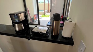 A kitchenette with a coffee maker, a kettle, and a toaster on the counter. - House 18 | Private Pool, Gourmet Area and 4 Suites - Near the City Center. (Barreirinhas)
