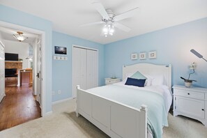 A bedroom with a bed, nightstands, a ceiling fan, a door, and a small plant. - Welcoming The Sinclair Hideaway (Sparta)