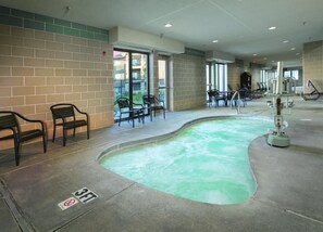 A swimming pool area with exercise equipment, chairs, and a 3ft no diving sign. - Spacious 1-bedroom condo 10 min walk from the national park! (West Yellowstone)