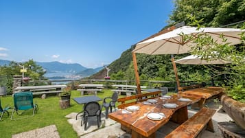 An outdoor dining area with a view of mountains and a lake.