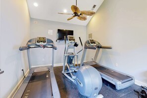 A gym with treadmills, a stationary bike, and a ceiling fan. - Rehoboth Crossing - 36983 Grindstone Ln. (Rehoboth Beach)