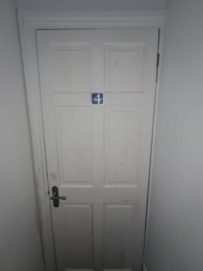 A white door with a number '4' sign on it. - The Oaks (Grays)