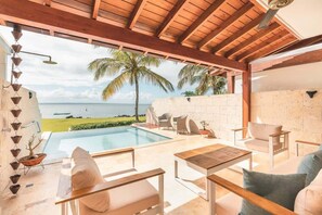 An outdoor pool area with a view of the ocean, wooden pergola, and seating arrangements. - 3br 6 Guests  Ocean view private pool (Sánchez)