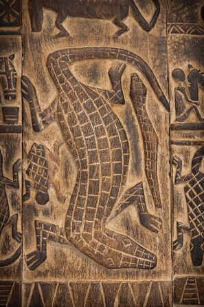 A carved wooden panel with a snake design and geometric patterns. - Zanzibar Adults-Only Deluxe (Paje)