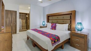 A bedroom with a bed, nightstands, a ceiling fan, and a wardrobe. - Family oasis near the sea - La Cruz Encantada 3A (La Cruz de Huanacaxtle)