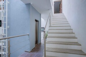 A staircase with a handrail leading to an upper floor. - Family oasis near the sea - La Cruz Encantada 3B (La Cruz de Huanacaxtle)
