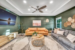 A living room with a sofa, coffee table, and decorative items.