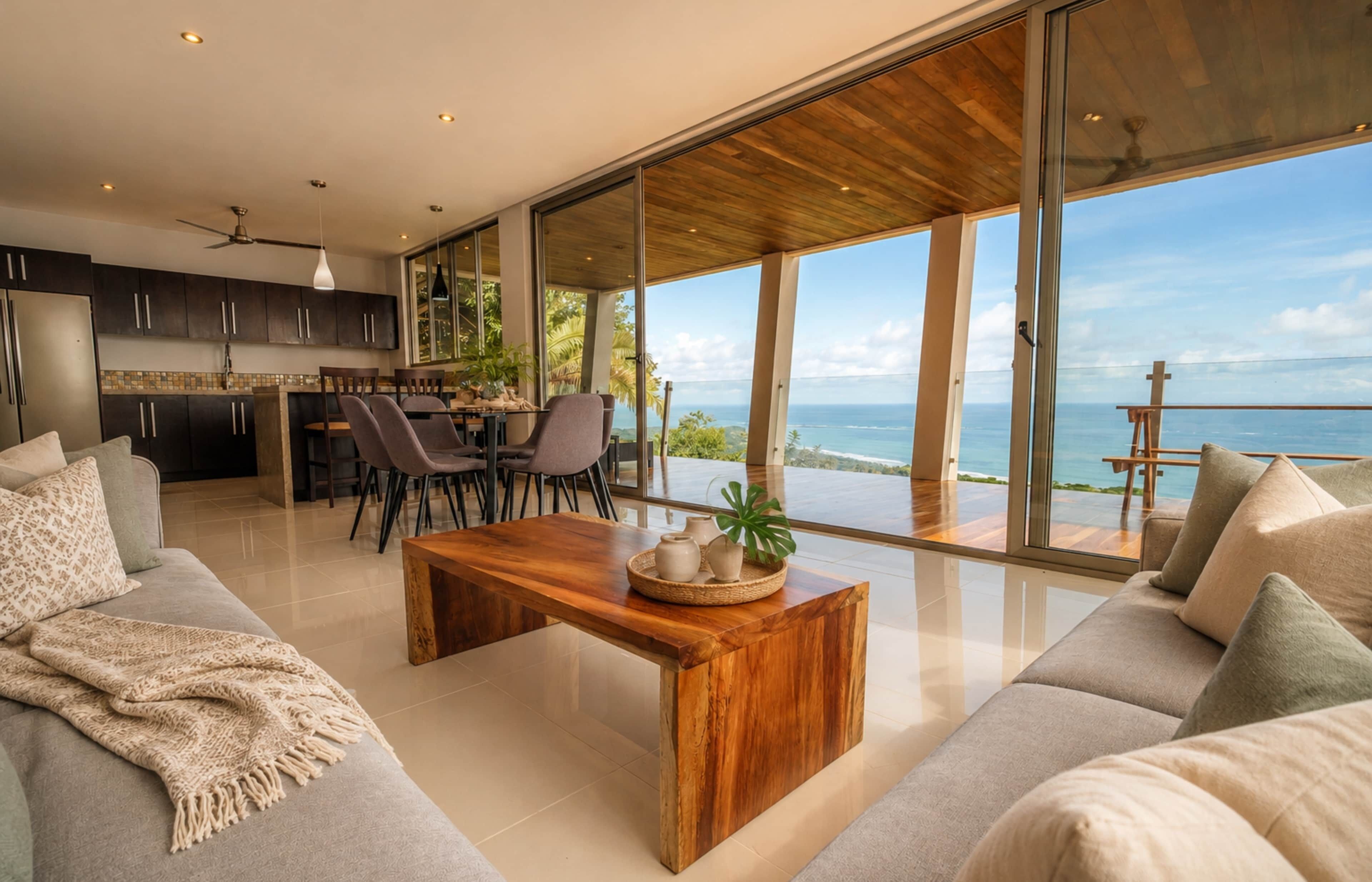 A modern living area with a wooden coffee table, a sofa, and a dining table with chairs.