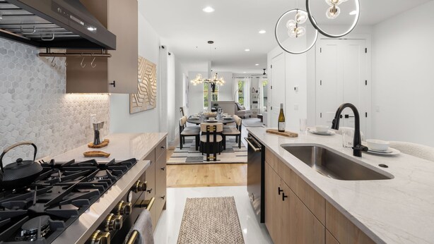 A modern kitchen with a gas stove, stainless steel sink, and pendant lighting. - Velvet Note@ The New Cumberland Side B (Nashville)