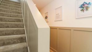 A staircase with carpeted steps leading to a landing. - Nevis Bridge House (Fort William)