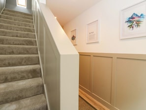 A staircase with carpeted steps leading to a landing. - Nevis Bridge House (Fort William)