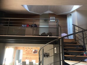 A multi-level interior with a staircase, wooden panel walls, and a ceiling with a skylight. - Beautiful house nearby is operational (La Teste-de-Buch)