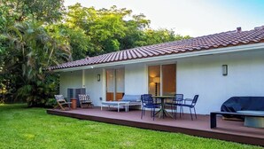 A house with a patio, outdoor seating, and a lawn. - 2-Acre Estate: Private Padel Court + Par-3 Golf (Davie)