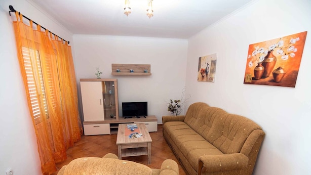 A living room with a sofa, a coffee table, a TV, and a cabinet. - Superior Two Bedroom Apartment with Sea View and Terrace (Rab)