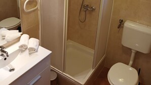 A bathroom with a shower, toilet, and sink. - Superior Two Bedroom Apartment with Sea View and Terrace (Rab)