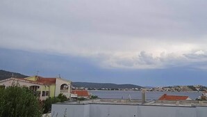 A coastal view with buildings and a body of water. - Classic One Bedroom Apartment with Sea View and Balcony (Rogoznica)