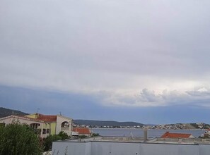A coastal view with buildings and a body of water. - Classic One Bedroom Apartment with Sea View and Balcony (Rogoznica)