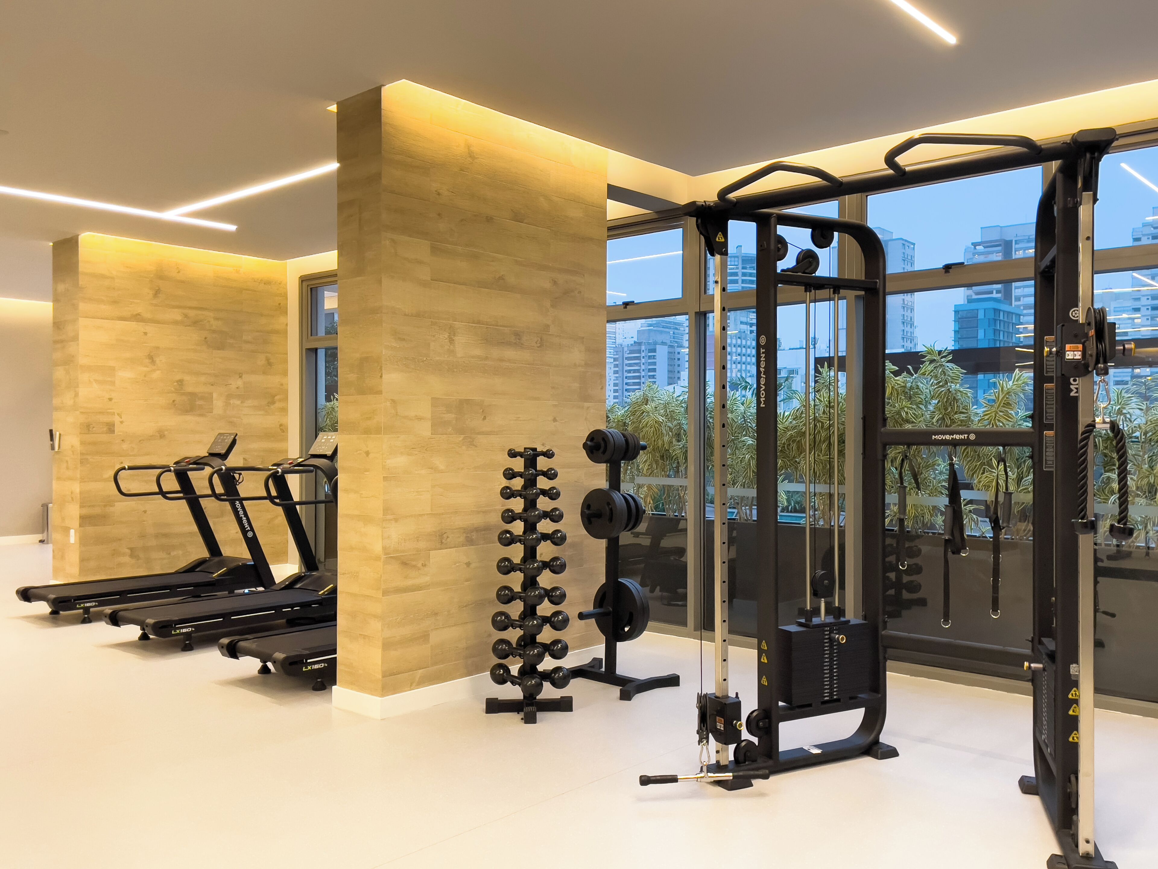 A gym with treadmills, a squat rack, and weightlifting equipment.