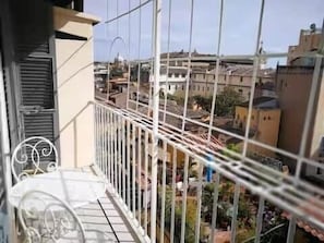 A balcony with a metal railing overlooking a residential area with buildings and a clear sky. - Campo de' Fiori | Panoramic View & 2 Bedrooms (Rome)