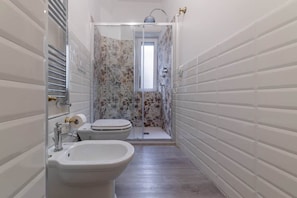 A bathroom with a shower, toilet, bidet, and sink. - Vatican Shabby double bedrooms (Rome)