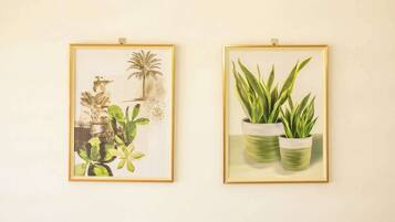 Two framed botanical illustrations on a wall.