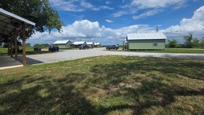 A campground with multiple cabins, a covered picnic area, and a gravel parking lot. - The Crappie Cabin #5
When a tent just won't do! (Abbeville)