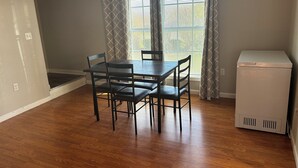 A dining area with a table and chairs, a refrigerator, and a window with curtains. - A 2-story, 3-bedrooms, 2.5 bathrooms with 3 hospitals that are 1 - 25 miles away (Lowville)