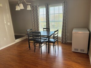 A dining area with a table and chairs, a refrigerator, and a window with curtains. - A 2-story, 3-bedrooms, 2.5 bathrooms with 3 hospitals that are 1 - 25 miles away (Lowville)