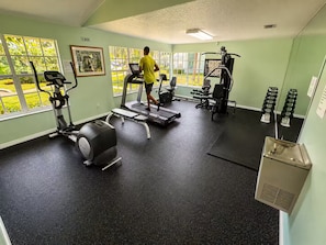 A gym with treadmills, weight machines, and a bench. - Family Getaway Near Disney • Pool & Hot Tub (Kissimmee)