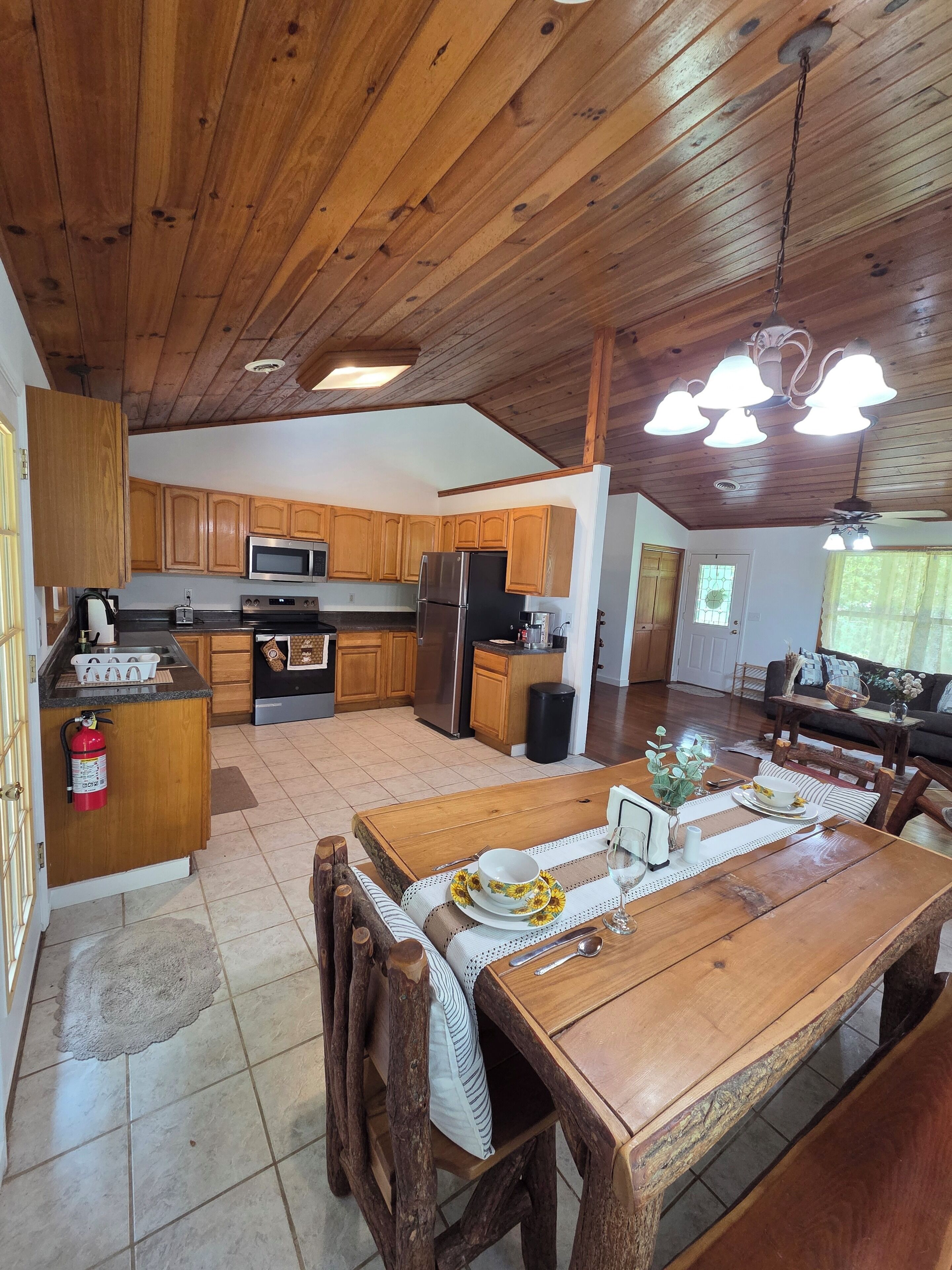 A spacious kitchen with wooden cabinets, a central island, and modern appliances.