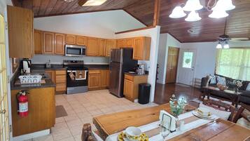 A spacious kitchen with wooden cabinets, a central island, and modern appliances.
